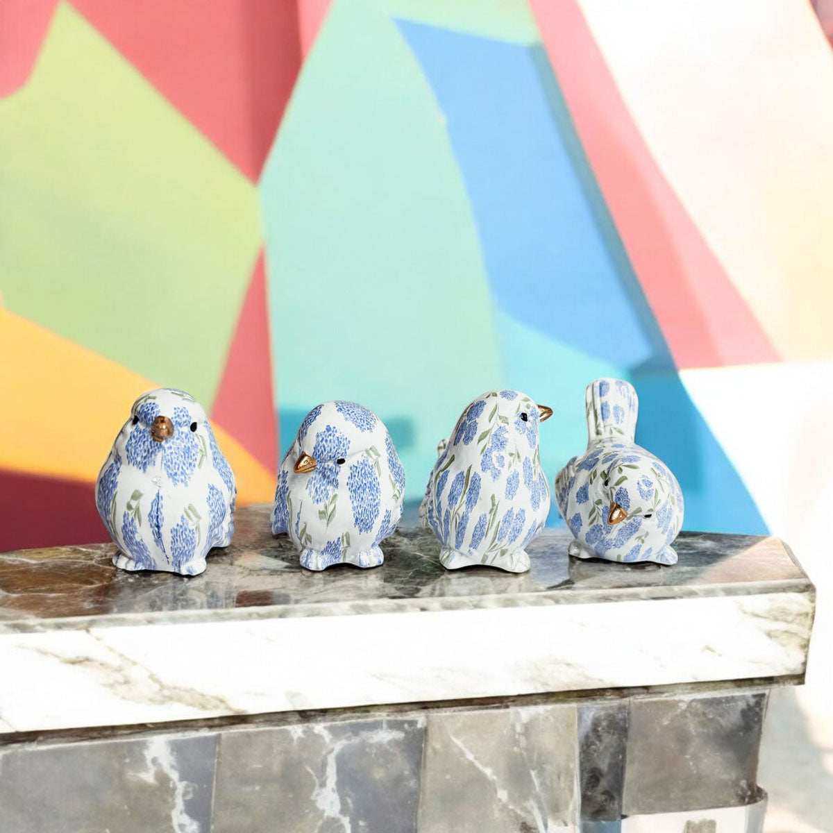 Charming blue hydrangea bird figurines with intricate floral patterns, ideal for indoor decoration.