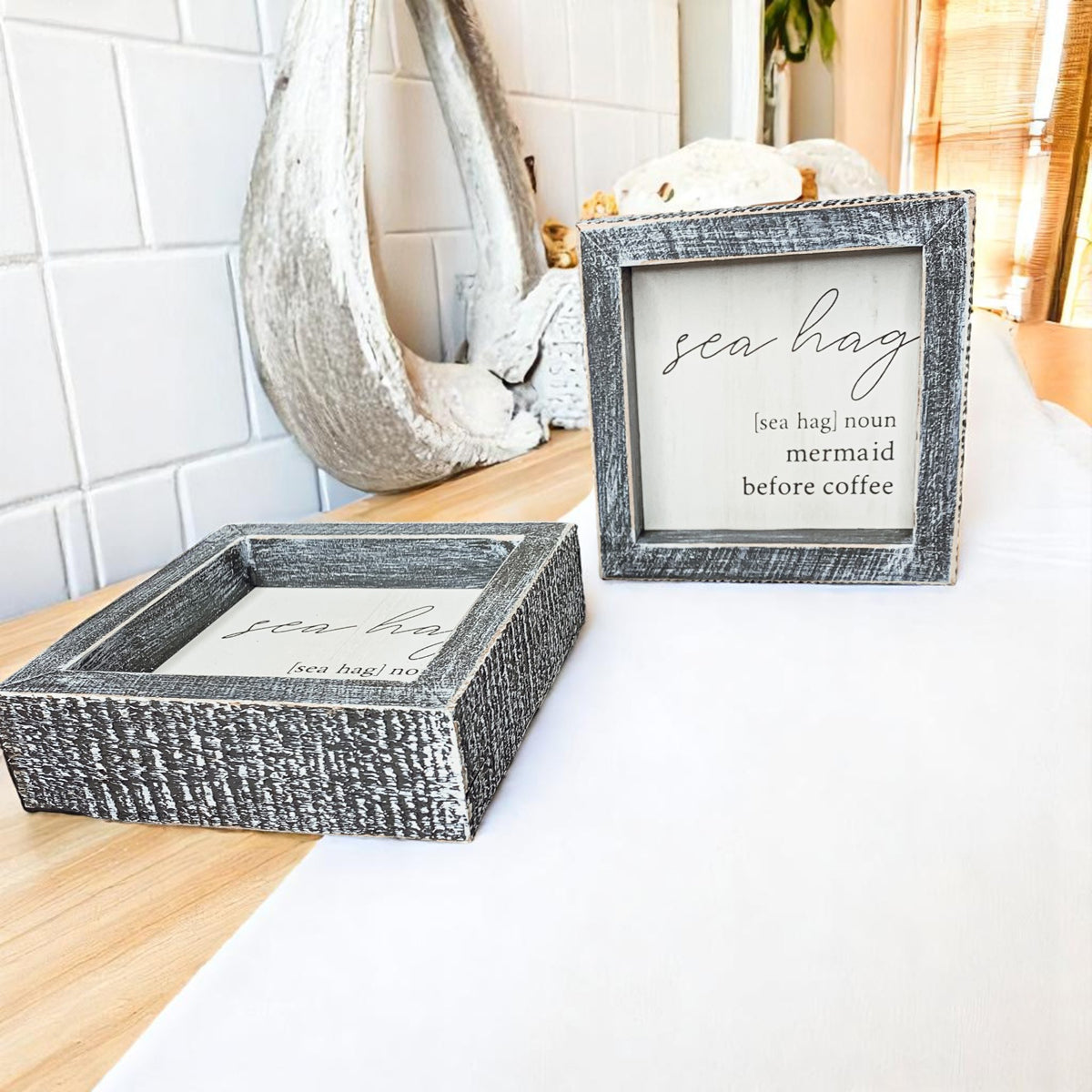 Rustic coastal kitchen sign with humorous sea definition"